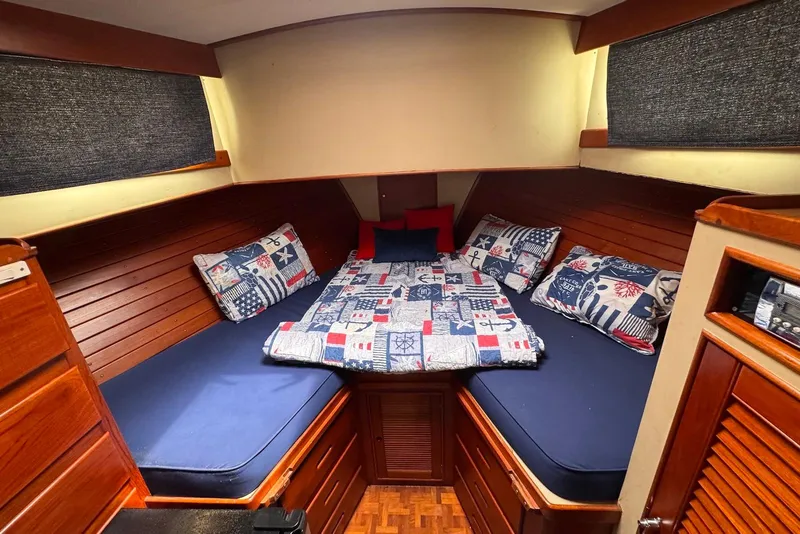 Slide: The Image of Cozy cabin interior of 1989 Grand Banks 42 Motoryacht with nautical-themed bedding. - 40