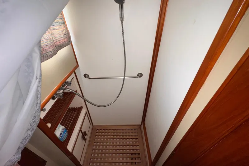 Slide: The Image of Shower area in 1989 Grand Banks 42 Motoryacht with wooden floor and curtain. - 44