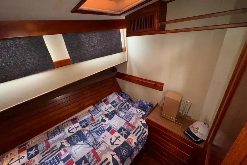 Slide: The Image of Cozy cabin interior of 1989 Grand Banks 42 Motoryacht with nautical-themed bedding. - 46