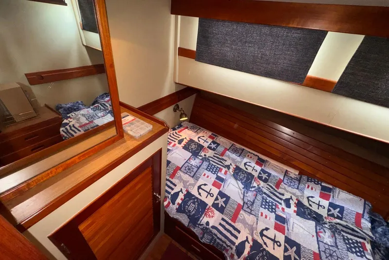 Slide: The Image of Cozy cabin interior of 1989 Grand Banks 42 Motoryacht with nautical-themed bedding. - 47
