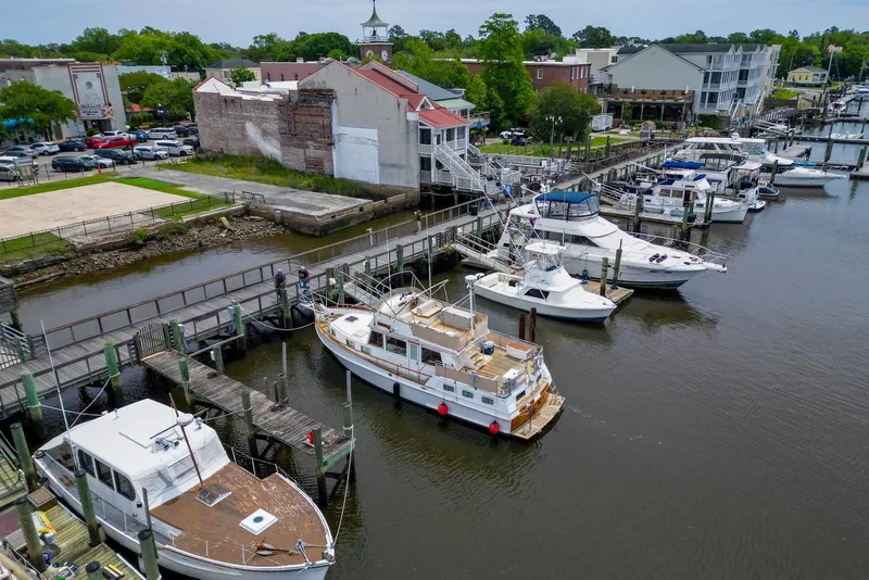 Slide: The Image of Docked 1989 Grand Banks 42 Motoryacht in a scenic marina setting. - 5