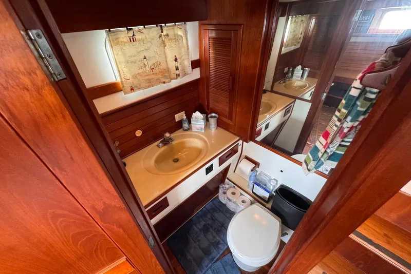 Slide: The Image of Bathroom interior of 1989 Grand Banks 42 Motoryacht with wooden cabinetry and nautical decor. - 50