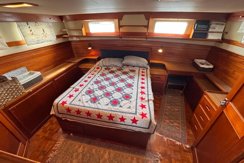 Slide: The Image of Cozy bedroom in 1989 Grand Banks 42 Motoryacht with quilted bedspread and wooden interior. - 52