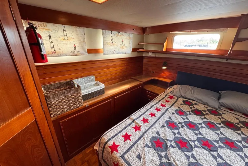 Slide: The Image of Cozy cabin interior of 1989 Grand Banks 42 Motoryacht with nautical decor and quilted bedding. - 53