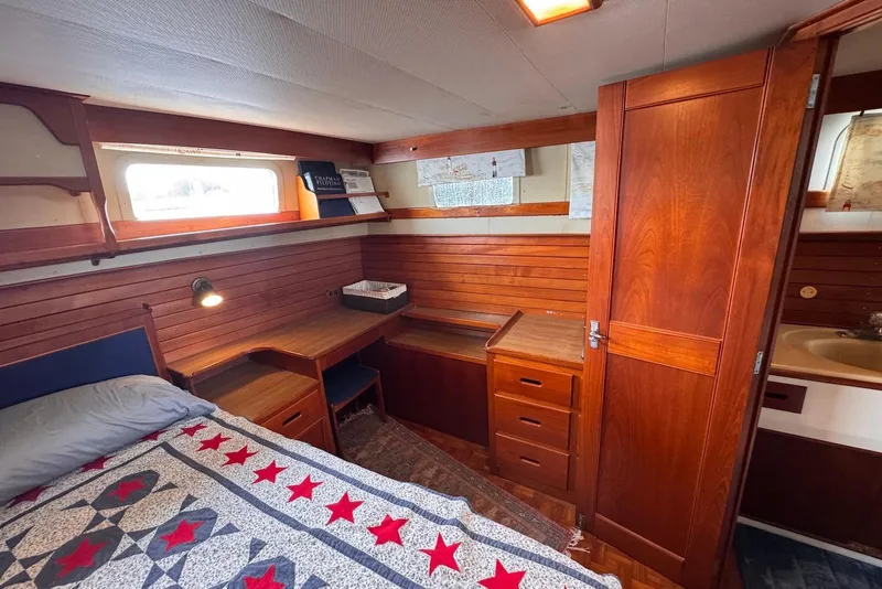 Slide: The Image of Cozy cabin interior of 1989 Grand Banks 42 Motoryacht with wooden furnishings and nautical decor. - 54