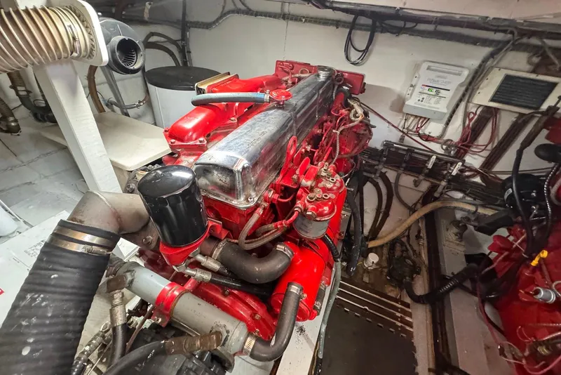 Slide: The Image of Engine room of 1989 Grand Banks 42 Motoryacht with red engine components. - 57