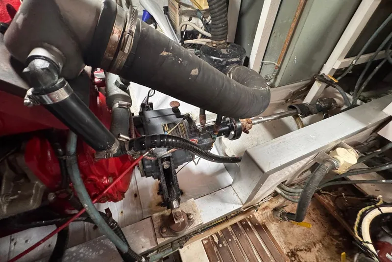 Slide: The Image of Engine room of a 1989 Grand Banks 42 Motoryacht, showcasing mechanical components and piping. - 64