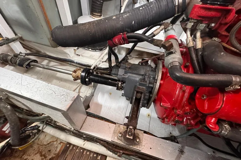 Slide: The Image of Engine room of 1989 Grand Banks 42 Motoryacht, showcasing mechanical components and hoses. - 65