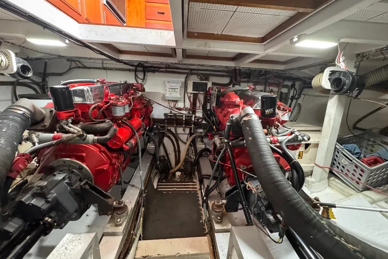 Slide: The Image of Engine room of a 1989 Grand Banks 42 Motoryacht with dual red engines. - 66