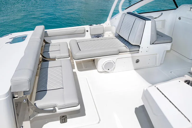 Slide: The Image of Manufacturer Provided Image: 2025 Pursuit DC 246 Dual Console boat interior with cushioned seating and sleek design. - 13