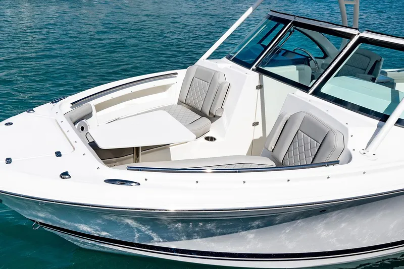 Slide: The Image of Manufacturer Provided Image: 2025 Pursuit DC 246 Dual Console boat on water, featuring sleek design and comfortable seating. - 6