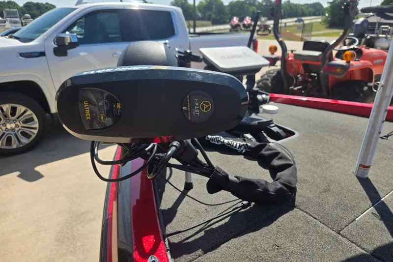 Slide: The Image of Trolling motor on 2012 Stratos 189 VLO boat, parked near vehicles and equipment. - 13