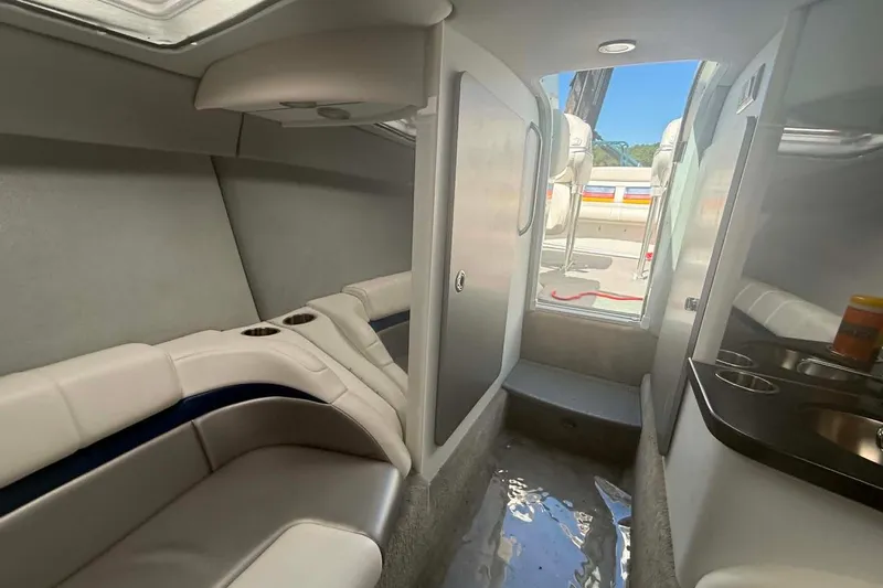 Slide: The Image of Interior of a 2007 Formula 353 FASTech boat, featuring seating and a compact kitchenette. - 10