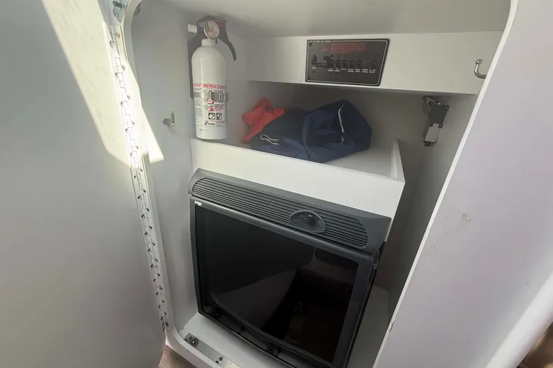 Slide: The Image of 2007 Formula 353 FASTech cabin with fire extinguisher, control panel, and storage area. - 12