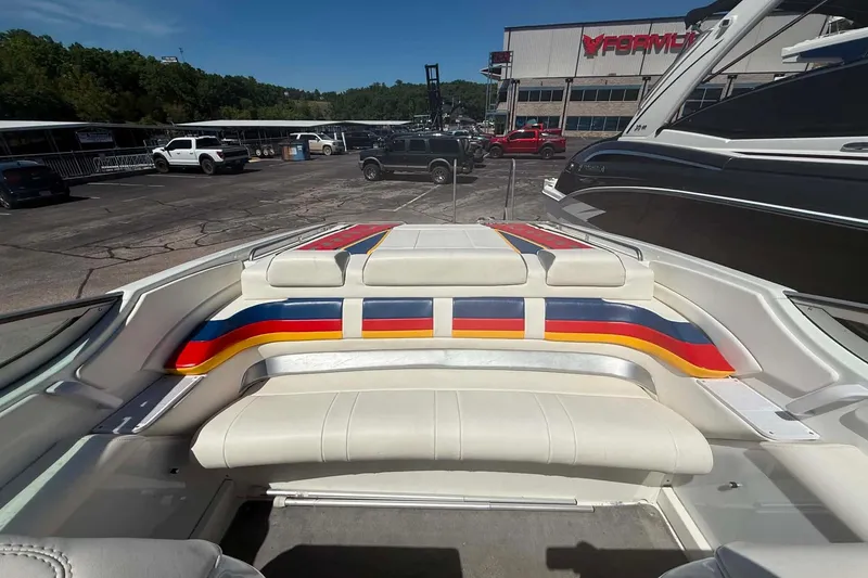 Slide: The Image of 2007 Formula 353 FASTech boat with colorful seating, parked outdoors near dealership. - 17