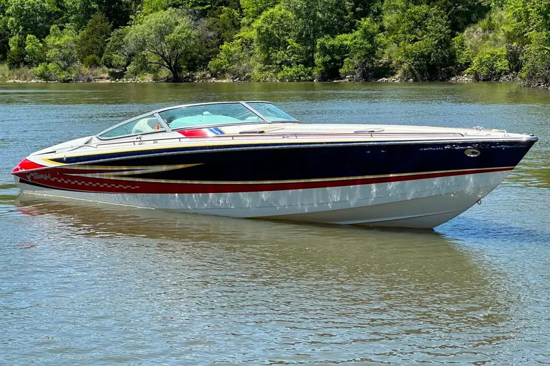 Slide: The Image of 2007 Formula 353 FASTech boat on calm water, surrounded by lush greenery. - 2