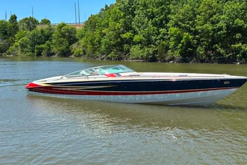 Slide: The Image of 2007 Formula 353 FASTech boat cruising on a calm river with lush green trees. - 3