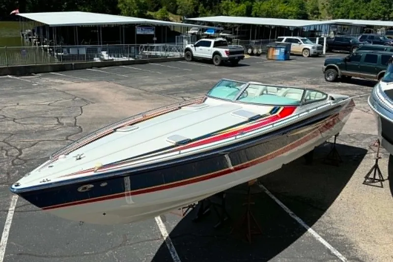 Slide: The Image of 2007 Formula 353 FASTech speedboat on display in a marina parking lot. - 6