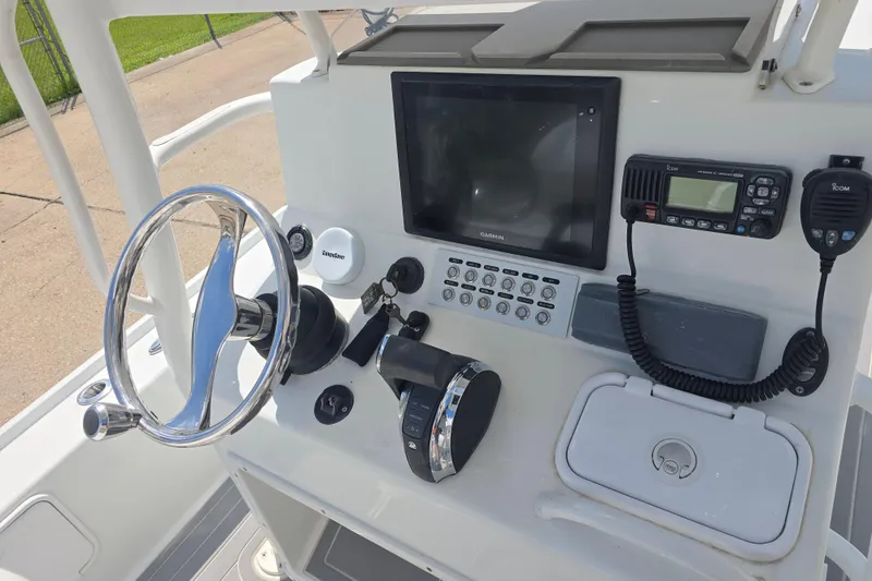 Slide: The Image of 2007 Yellowfin 24 Bay boat console with steering wheel, Garmin display, and communication equipment. - 10