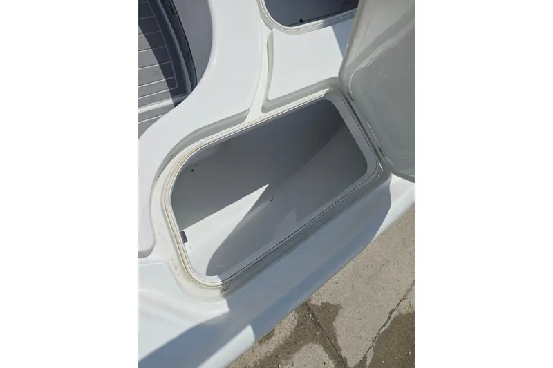 Slide: The Image of Open storage compartment on a 2007 Yellowfin 24 Bay boat, showcasing interior space. - 18