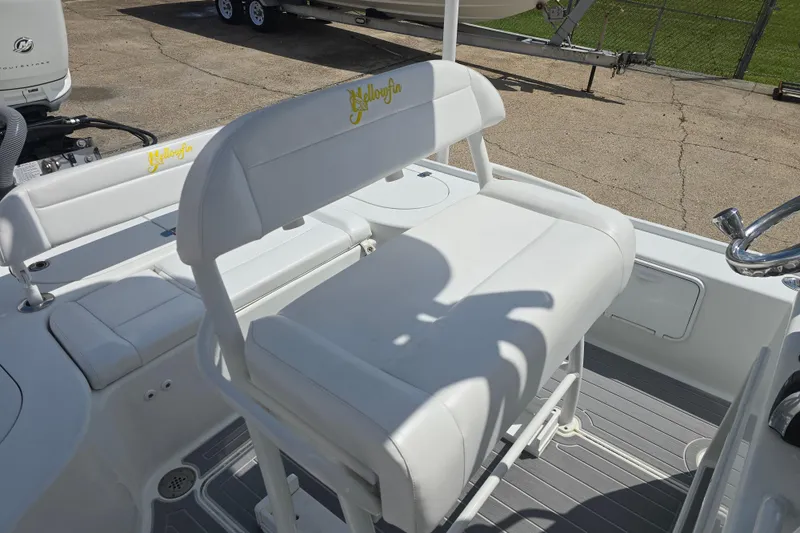 Slide: The Image of 2007 Yellowfin 24 Bay boat with white seating and logo, showcasing deck details. - 19