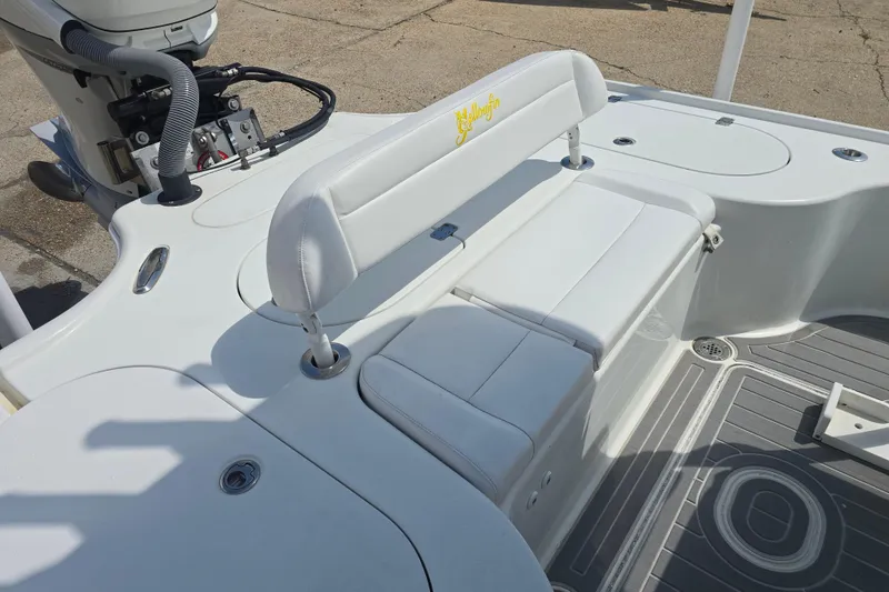 Slide: The Image of 2007 Yellowfin 24 Bay boat interior with white seating and motor details. - 20