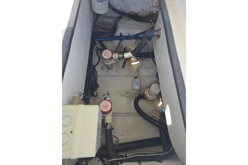 Slide: The Image of 2007 Yellowfin 24 Bay boat bilge area with pumps and wiring. - 21