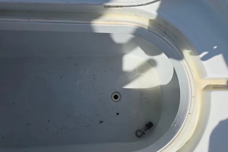 Slide: The Image of Empty livewell in a 2007 Yellowfin 24 Bay boat, showing drain and shadows. - 24