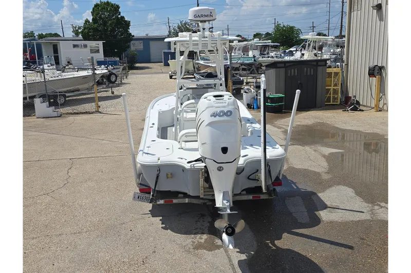 Slide: The Image of 2007 Yellowfin 24 Bay boat with powerful outboard motor in a marina setting. - 3