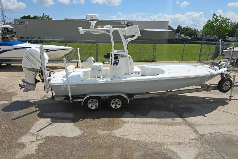 Slide: The Image of 2007 Yellowfin 24 Bay boat on trailer, parked outdoors under a clear sky. - 5