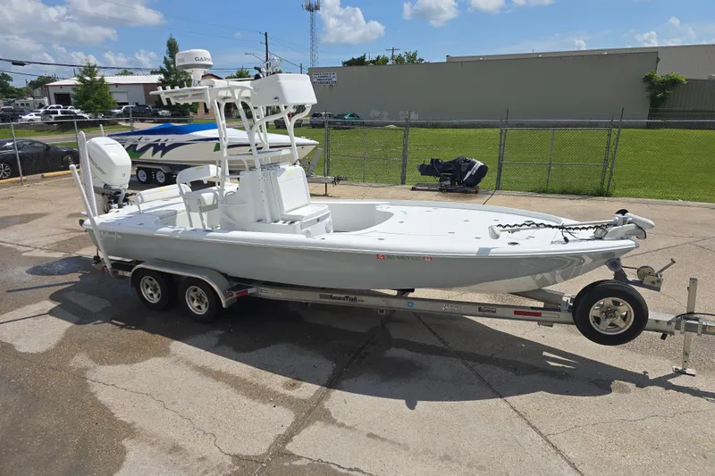 Slide: The Image of 2007 Yellowfin 24 Bay boat on trailer, parked outdoors under a clear sky. - 6