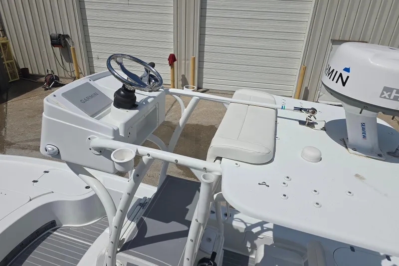 Slide: The Image of 2007 Yellowfin 24 Bay boat with Garmin electronics and Seaview mount, docked near a garage. - 9