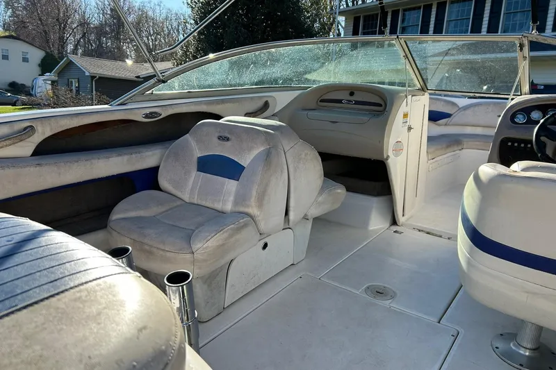 Slide: The Image of 2003 Chaparral 21 SSi boat interior with seating and dashboard, showcasing spacious design. - 11