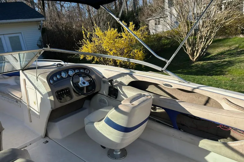 Slide: The Image of 2003 Chaparral 21 SSi boat interior with steering wheel and dashboard, parked outdoors. - 7