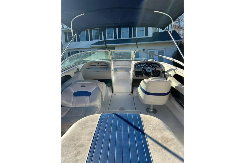 Slide: The Image of 2003 Chaparral 21 SSi boat interior with blue and white seating under a canopy. - 9