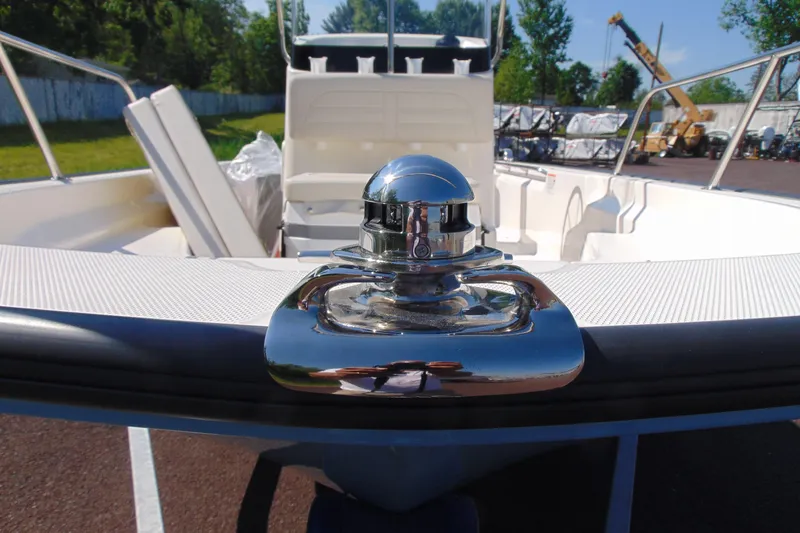 Slide: The Image of 2026 Boston Whaler 150 Montauk boat deck with chrome cleat, outdoor setting. - 10