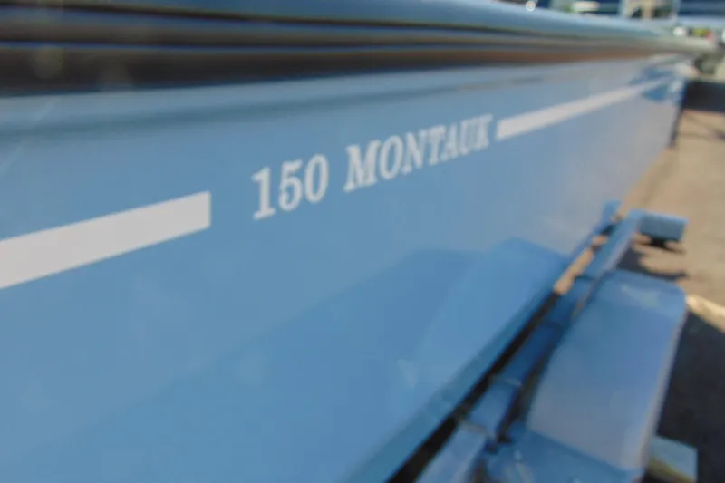 Slide: The Image of 2026 Boston Whaler 150 Montauk boat side view with model name visible. - 11