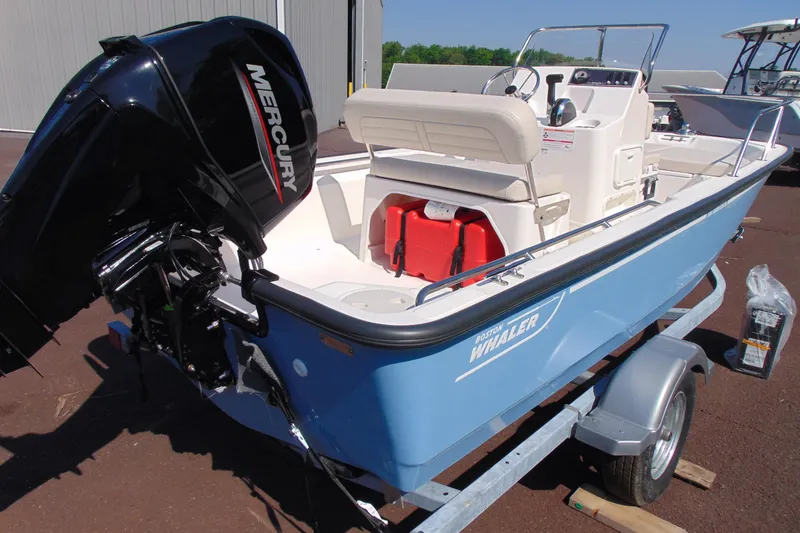 Slide: The Image of 2026 Boston Whaler 150 Montauk boat with Mercury engine on trailer. - 3