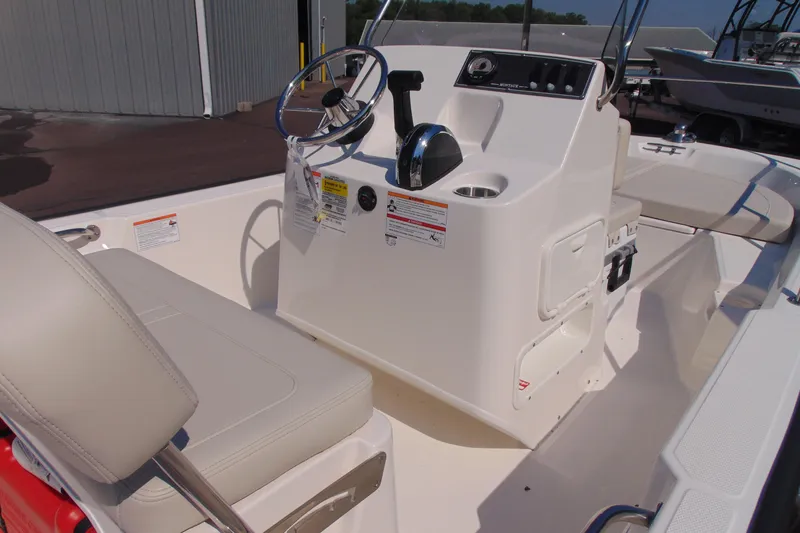 Slide: The Image of 2026 Boston Whaler 150 Montauk boat interior with steering console and seating. - 4