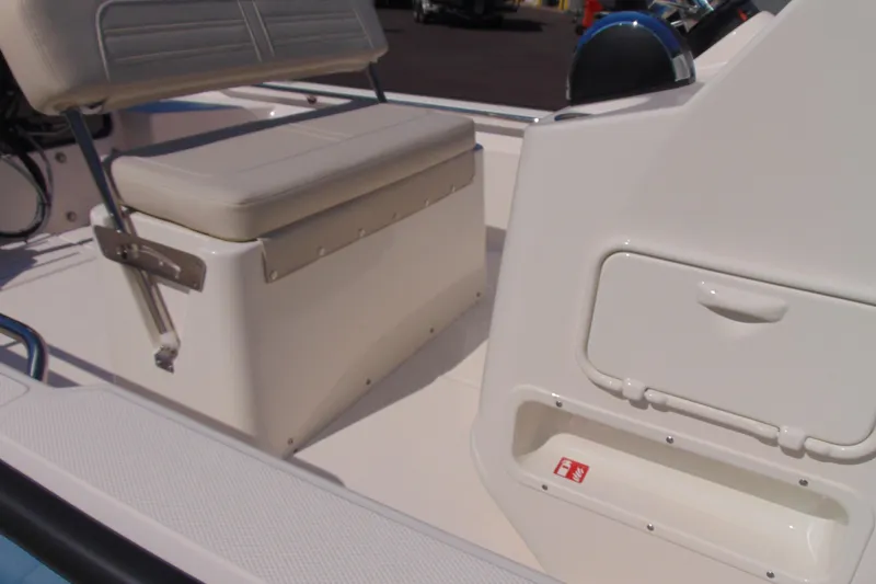 Slide: The Image of Interior view of 2026 Boston Whaler 150 Montauk boat, featuring seating and storage compartments. - 5
