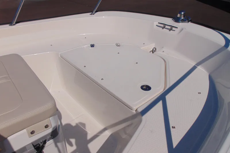 Slide: The Image of 2026 Boston Whaler 150 Montauk boat interior with seating and storage area. - 7
