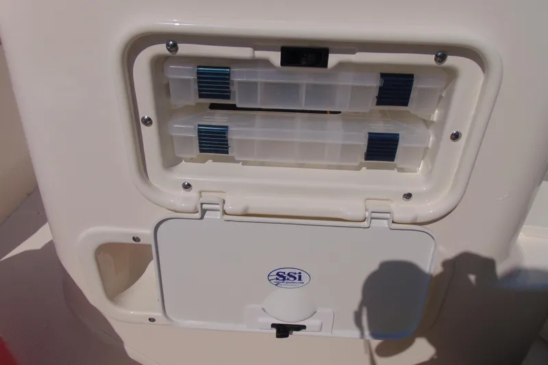 Slide: The Image of Storage compartment on a 2026 Boston Whaler 150 Montauk boat, featuring SSI branding. - 8