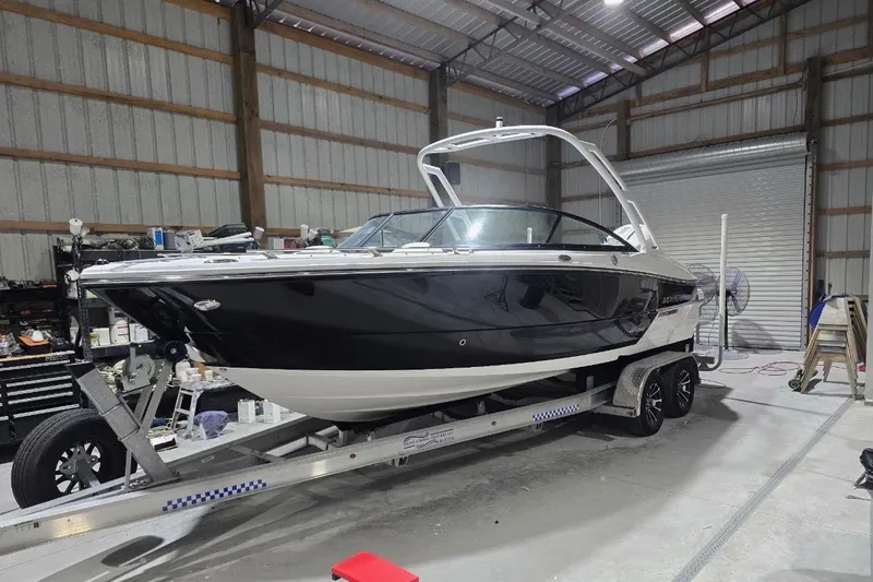 The Image of 2023 Monterey 235SS Super Sport boat on trailer in a garage setting. - 0