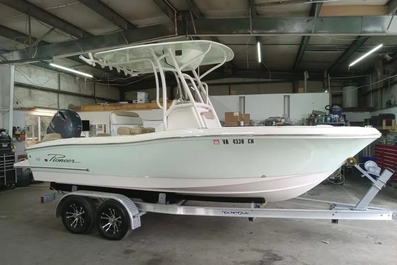 Slide: The Image of 2020 Pioneer 202 Islander boat on trailer in a garage setting. - 3