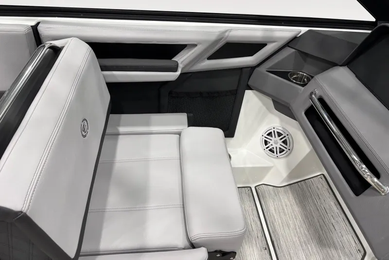 Slide: The Image of 2026 Cobalt R4 boat interior with gray seating, speaker, and cup holder. - 10