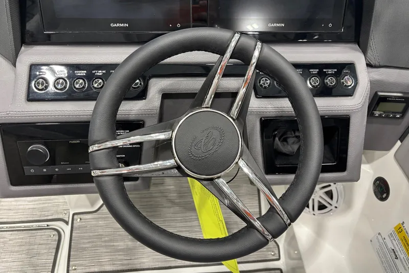 Slide: The Image of Steering wheel of 2026 Cobalt R4 boat with modern dashboard controls. - 12
