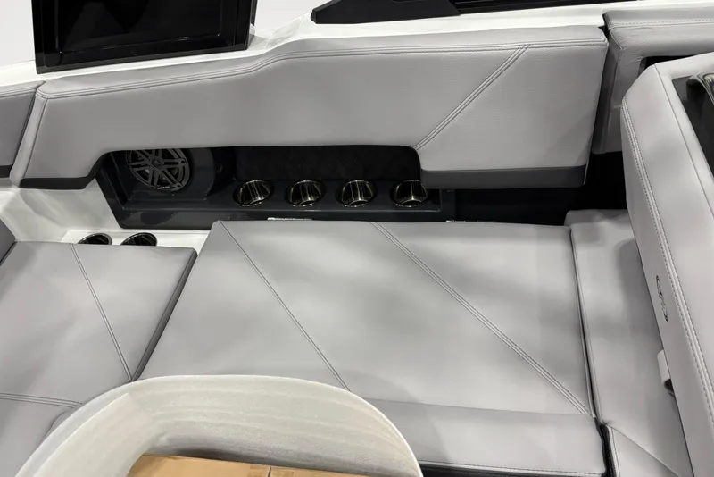 Slide: The Image of 2026 Cobalt R4 boat interior with gray seating and integrated cup holders. - 13
