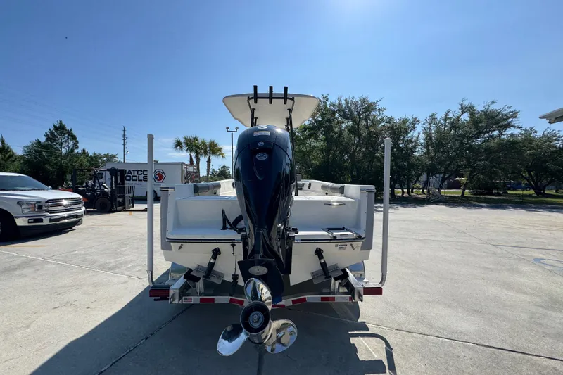 Slide: The Image of 2027 Sea Born LX21 Center Console boat on trailer, rear view in sunny outdoor setting. - 12