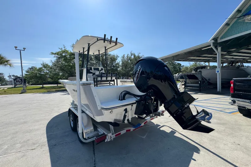Slide: The Image of 2027 Sea Born LX21 Center Console boat on trailer, parked outdoors. - 13
