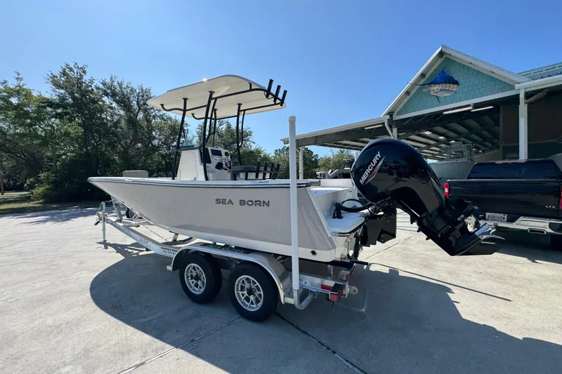 Slide: The Image of 2027 Sea Born LX21 Center Console boat on trailer, parked outdoors. - 14